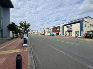 Discover a prime commercial location in a vibrant Japanese town, featuring a mix of retail and service businesses.