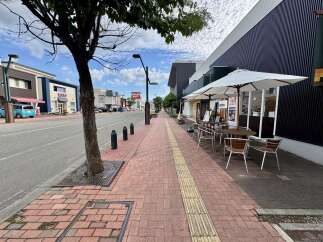 Discover this charming commercial space with a prime street-facing location, perfect for a cafe or retail business.