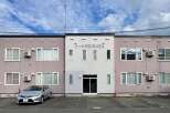Discover modern living in this well-maintained apartment building, featuring a prominent 'SHIBATA' sign.