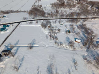 Discover this charming rural property nestled in a serene winter landscape.