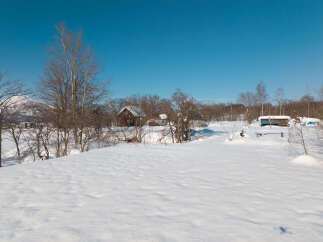 Experience serene winter living in this charming property nestled amidst snow-covered landscapes.