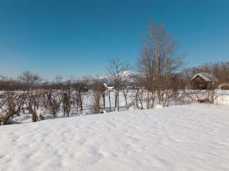 Experience the serene beauty of a winter wonderland with this charming property nestled amidst snow-covered landscapes.
