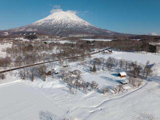 Experience the serene beauty of a winter wonderland with this charming property nestled amidst snow-covered landscapes.