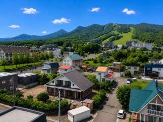 Discover this charming residential area nestled amidst lush green mountains, offering a serene escape with a blend of modern homes and traditional architecture.