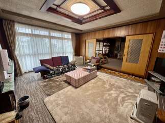 Experience comfort and style in this inviting living space, featuring a plush sofa and a charming checkered coffee table.