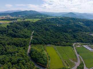 Discover this expansive parcel of land, nestled amidst rolling hills and lush greenery.
