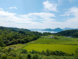 Discover serene living with this stunning property offering panoramic views of rolling green hills and a tranquil lake.