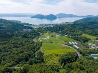 Discover this prime parcel of land, nestled amidst lush greenery and offering breathtaking panoramic views of the serene lake and distant mountains.