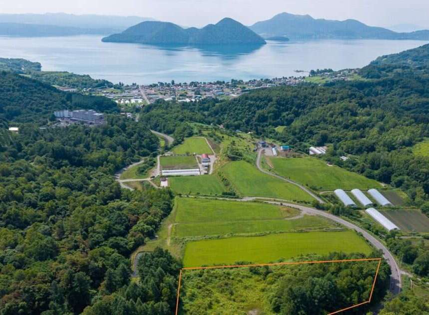 Discover this prime real estate opportunity with stunning panoramic views of a serene lake and distant mountains.