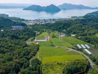 Discover this prime real estate opportunity with stunning panoramic views of a serene lake and distant mountains.