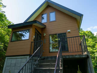 Nestled amidst lush greenery, this charming brown house offers a serene retreat.