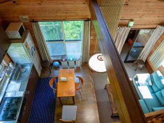 Experience cozy living in this charming wooden cabin, featuring a well-equipped kitchenette with a gas stove and sink.