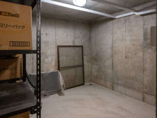 Discover ample storage solutions in this property's dedicated storage room, featuring sturdy shelving units perfect for organizing belongings.