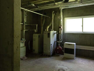 Discover the practical utility of this basement space, featuring essential mechanical systems including a water heater and a furnace.