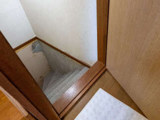 Discover the potential of this space with a view of the staircase leading down to a basement area.
