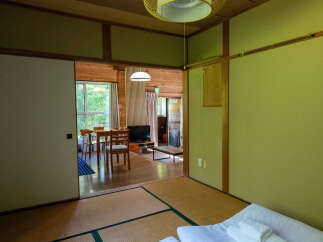 Experience serene living in this charming Japanese-style room, featuring traditional tatami flooring and shoji screens.