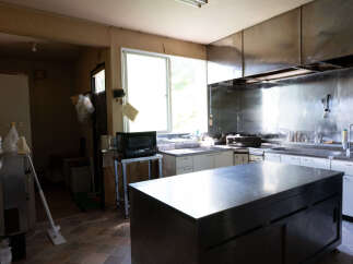 This spacious kitchen features a large stainless steel island, perfect for meal preparation and entertaining.