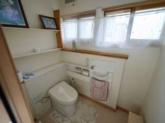 Discover this charming bathroom featuring a modern toilet and a compact sink, perfect for small spaces.