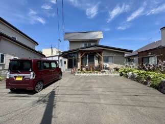 Discover this charming property featuring a spacious driveway with a maroon minivan, perfect for families.