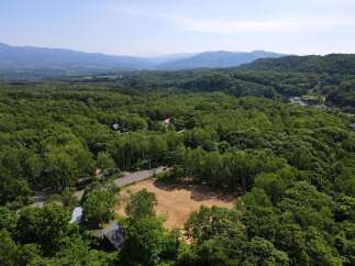 Discover this stunning property nestled amidst lush greenery, offering a serene escape with breathtaking mountain views.
