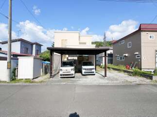 Discover this charming property featuring a covered carport with two modern vehicles, perfect for protecting your cars from the elements.