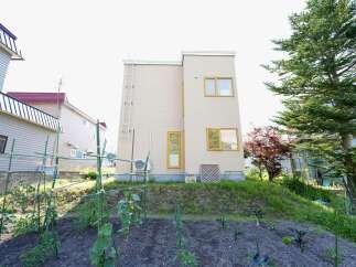 Discover this charming property featuring a modern beige house with yellow-trimmed windows, perfect for a serene lifestyle.