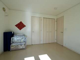 Discover this charming room featuring a set of light wood closet doors, perfect for ample storage.