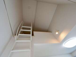 Ascend to a lofted space with this charming ladder, perfect for maximizing vertical room.
