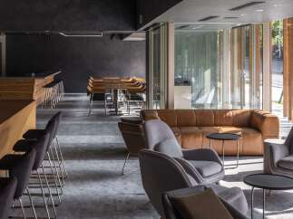 This modern commercial space features a sleek bar area with ample seating, perfect for a cafe or restaurant.