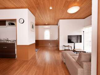 Discover this charming living space featuring a modern kitchen area with ample cabinet space and a sleek sink.