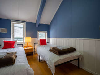 This charming bedroom features two twin beds, perfect for accommodating guests or family.