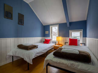 This charming bedroom features two twin beds, perfect for accommodating guests or family.