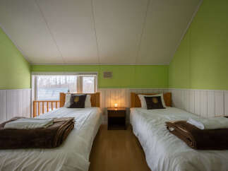 Discover this charming bedroom featuring two twin beds, perfect for accommodating guests or family.