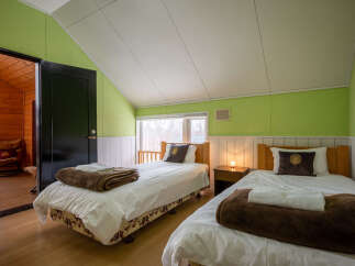 This charming bedroom features two twin beds, perfect for accommodating guests or family.