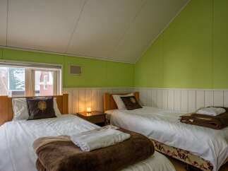This charming bedroom features two cozy twin beds, perfect for accommodating guests or family.
