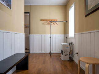 This versatile space features a convenient clothing rack and a comfortable bench, perfect for organizing and relaxing.