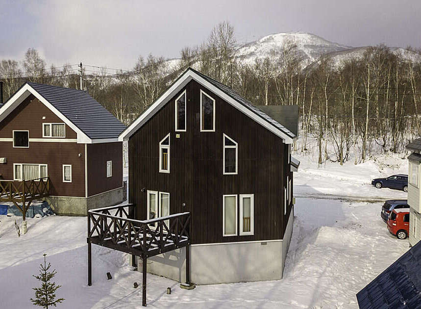Experience the charm of a winter wonderland with these picturesque chalets nestled in a snowy landscape.