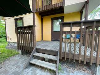 Enjoy outdoor living on this charming wooden deck, perfect for relaxing or entertaining.