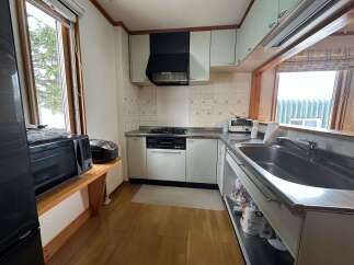 This cozy kitchen features a gas stovetop and oven, perfect for home chefs.
