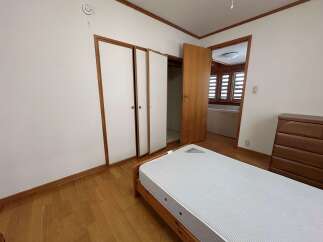 This bedroom features a comfortable bed with a striped mattress, perfect for a restful night's sleep.