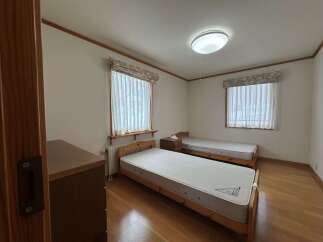 This charming bedroom features two twin beds with comfortable mattresses, perfect for accommodating guests or family.