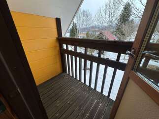 Enjoy the serene winter landscape from this charming balcony, perfect for a morning coffee or evening relaxation.