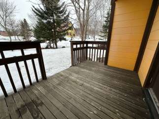 Enjoy the crisp winter air from this charming wooden deck, perfect for morning coffee or evening relaxation.