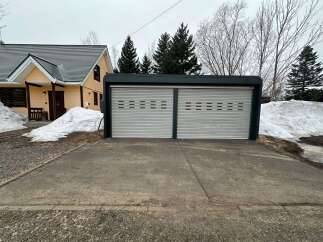 Discover this charming property featuring a cozy yellow house with a dark roof, perfect for a serene getaway.