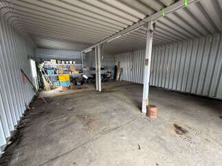 This spacious storage unit offers ample room for all your belongings, featuring durable metal construction and a high ceiling for maximum vertical storage.