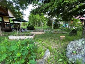 Discover a charming retreat with a multi-level home nestled amidst lush greenery and mature trees.