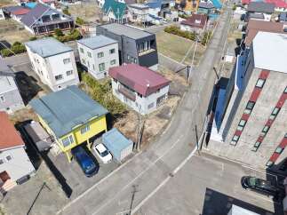 Discover this charming property featuring a two-story house with a distinctive maroon roof, nestled within a well-maintained lot.