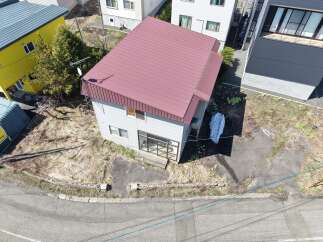 Discover this charming property featuring a distinctive red metal roof, offering a modern aesthetic.