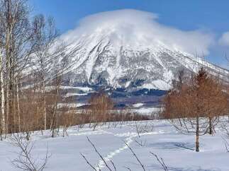 Experience the serene beauty of winter with this stunning mountain view, perfect for a tranquil retreat.