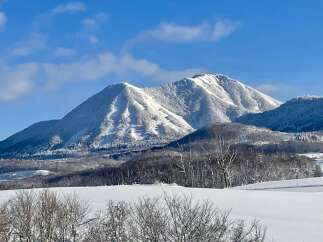 Experience the serene beauty of winter with this stunning mountain landscape, perfect for those seeking a tranquil escape.